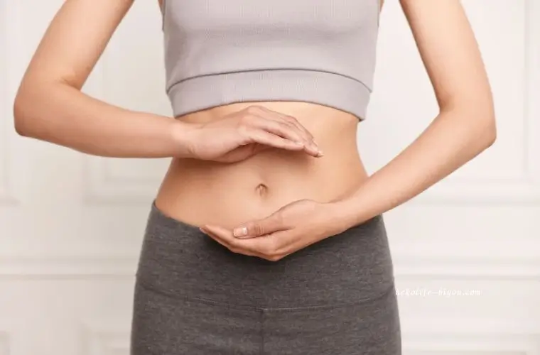 腸活している女性がお腹に手を当てている写真アロマで腸活｜お腹を温めて副交感神経を整える夜の温湿布ルーティン